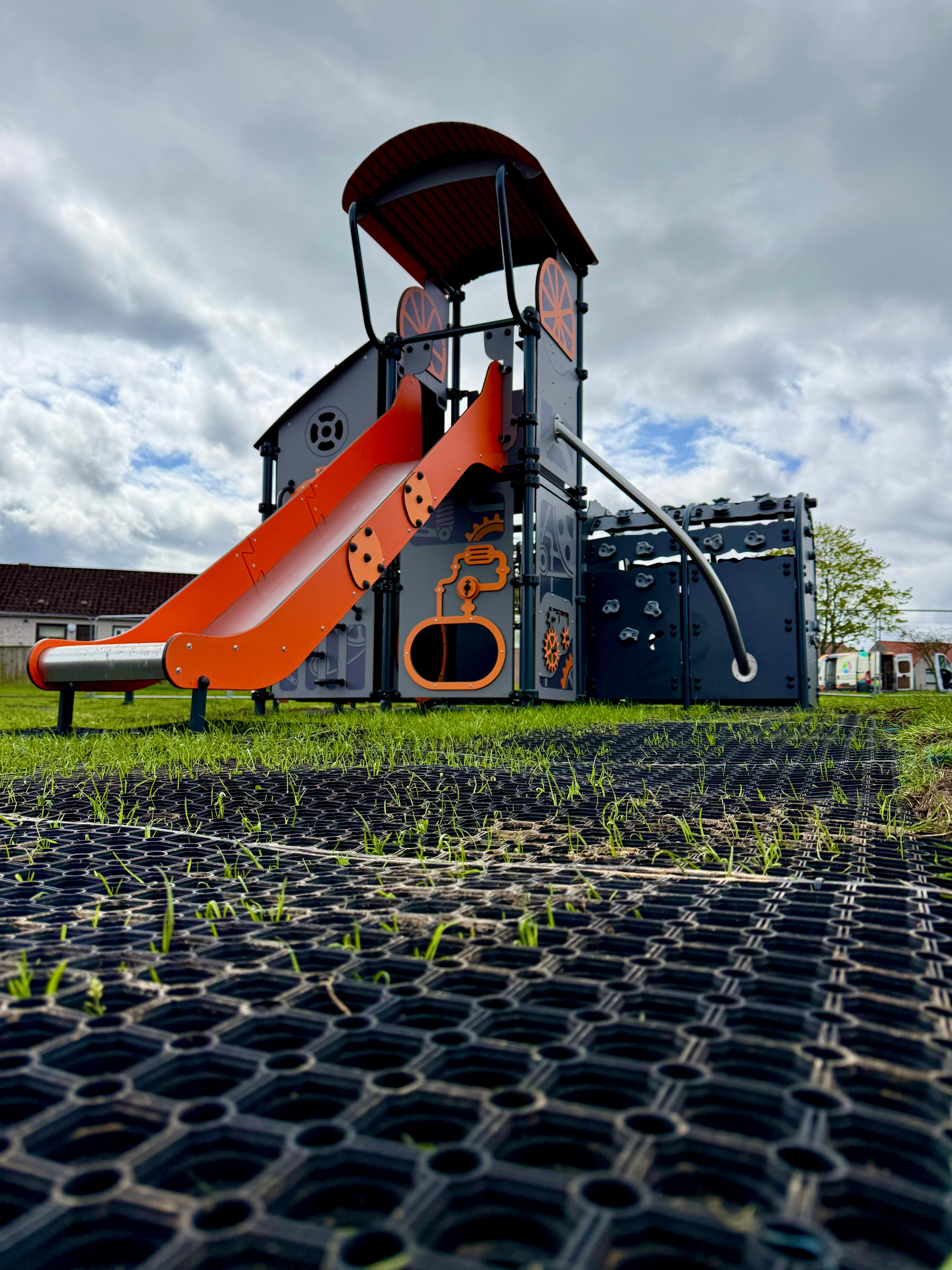 Community council play structure with climbing equipment and safety surfacing